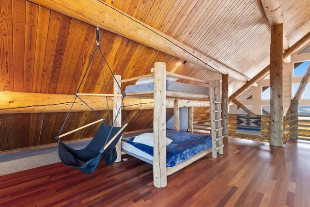 a view of a balcony with chairs and wooden floor