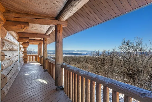 a view of a balcony with wooden floor
