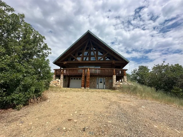 a view of a house with pool and sitting area