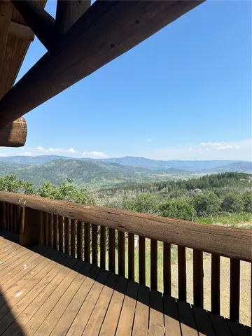 a balcony with wooden floor and city view
