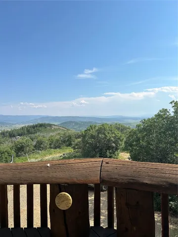 a view of balcony with wooden floor and city view