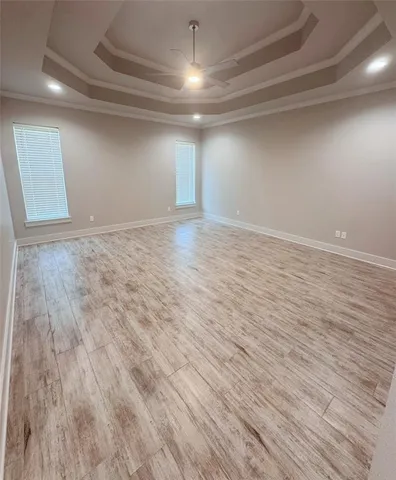a view of empty room with wooden floor