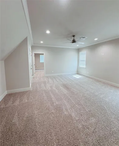 an empty room with a ceiling fan and a window