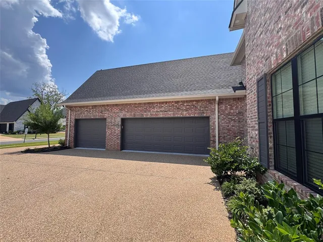 a front view of a house with yard and garage