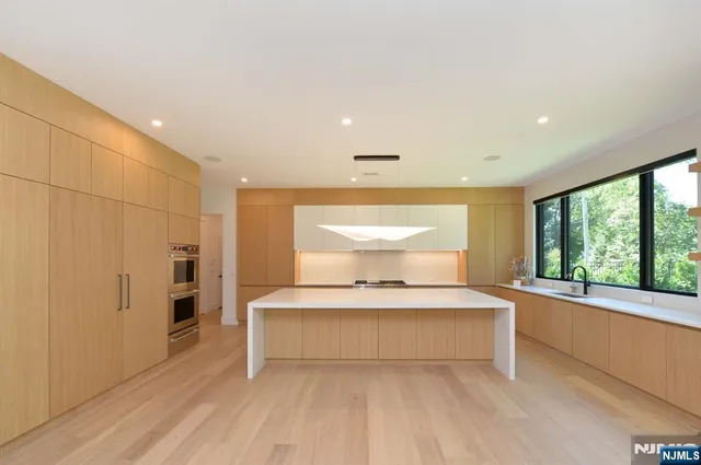 a bedroom with a large bed and a large window