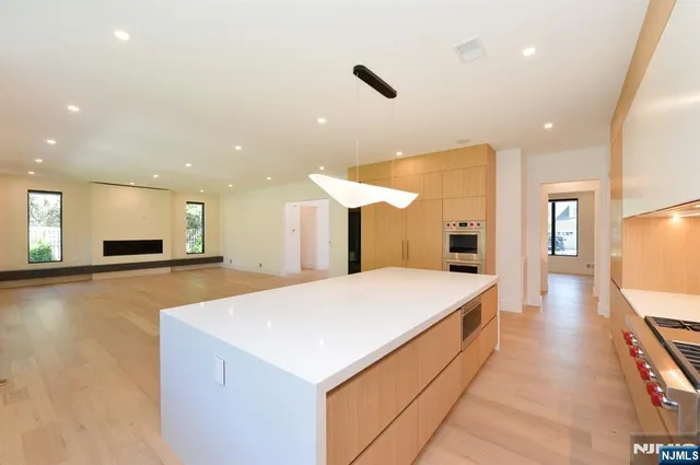 a large kitchen with a large counter top appliances and cabinets
