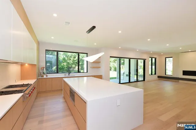 a large white kitchen with a large window