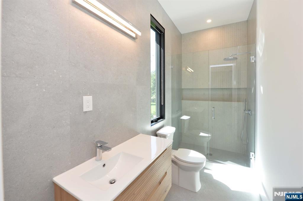 3 Central Avenue Demarest, NJ 07627 - Photo 15 of 49 a bathroom with a toilet a sink and mirror