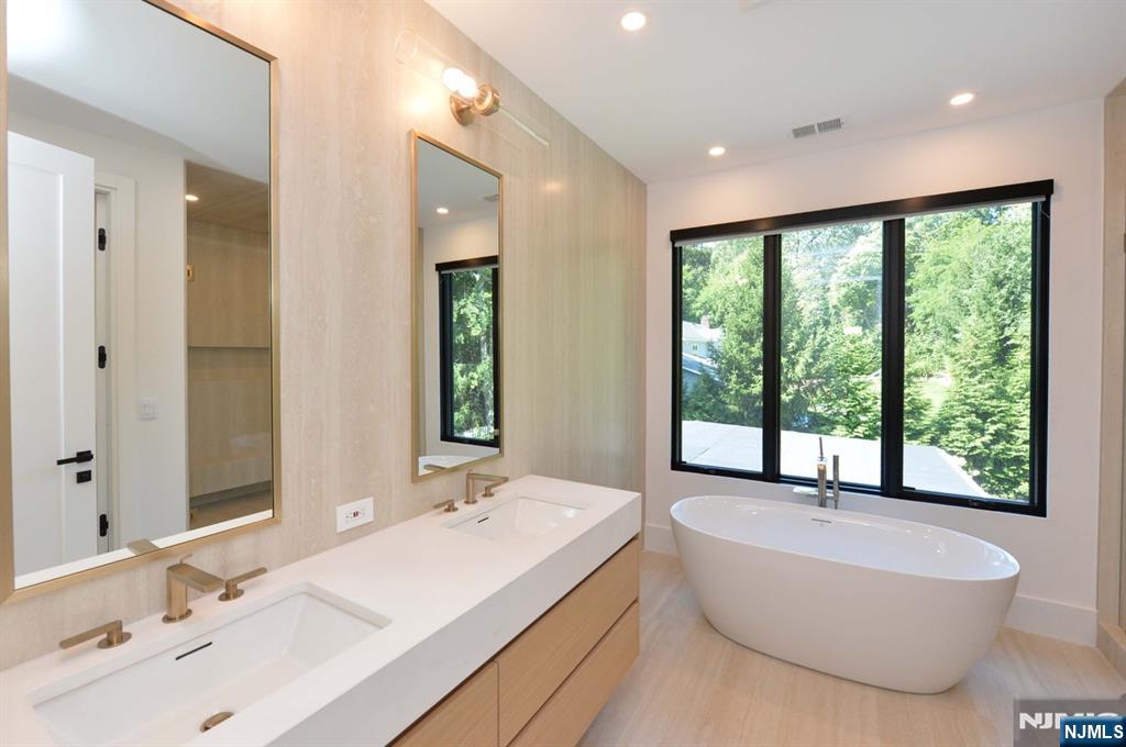 3 Central Avenue Demarest, NJ 07627 - Photo 25 of 49 a bathroom with a large tub sink and mirror
