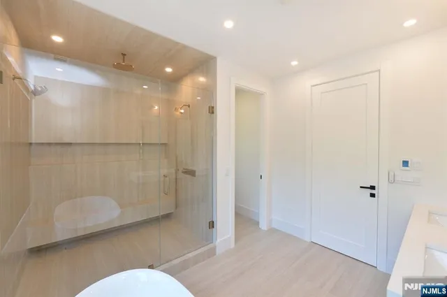 a bathroom with a shower a toilet and a sink