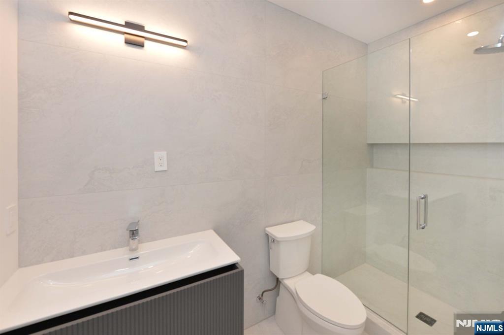 3 Central Avenue Demarest, NJ 07627 - Photo 31 of 49 a bathroom with a sink a toilet and shower