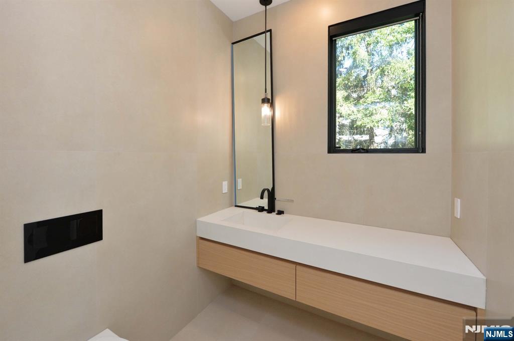 3 Central Avenue Demarest, NJ 07627 - Photo 7 of 49 a bathroom with a tub sink and mirror