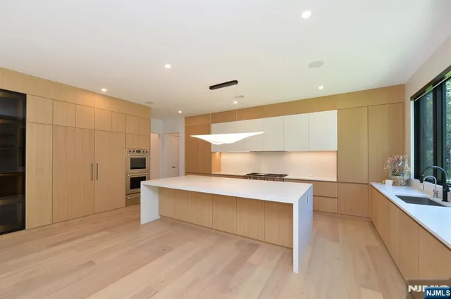 a living room with stainless steel appliances kitchen island granite countertop furniture and a kitchen view