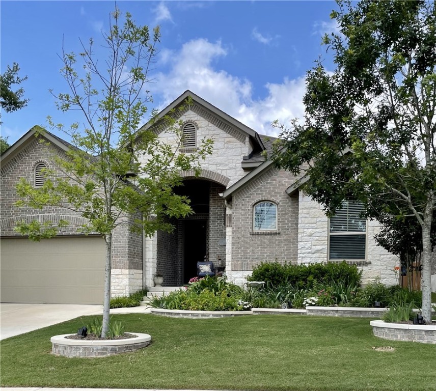 a front view of a house with a yard and garage