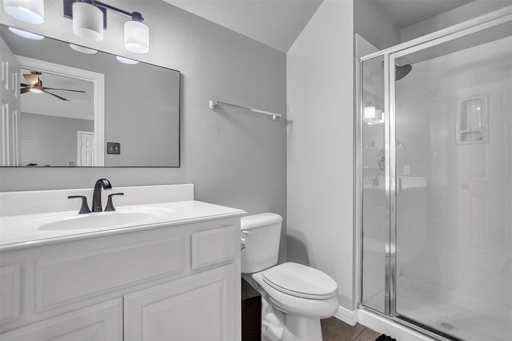 12286 Emerald Ranch Lane North Forney, TX 75126 - Photo 29 of 40 a bathroom with a sink toilet vanity and shower