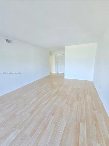 wooden floor with an empty room and window