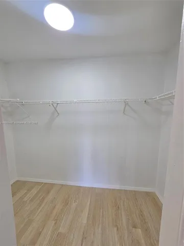 a bathroom with a granite countertop bathtub shower sink vanity and toilet