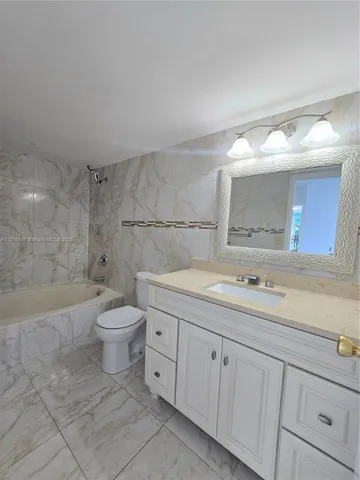 a bathroom with a double vanity sink a toilet and a mirror