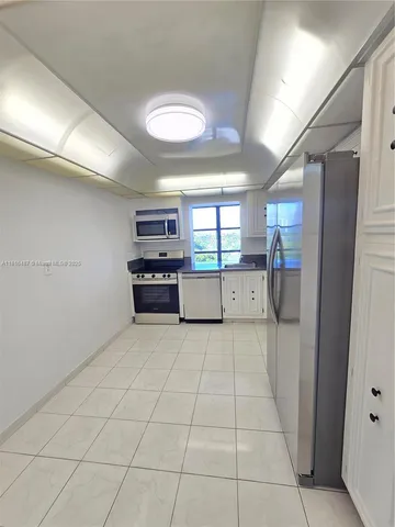 a view of a livingroom with an empty space and a window