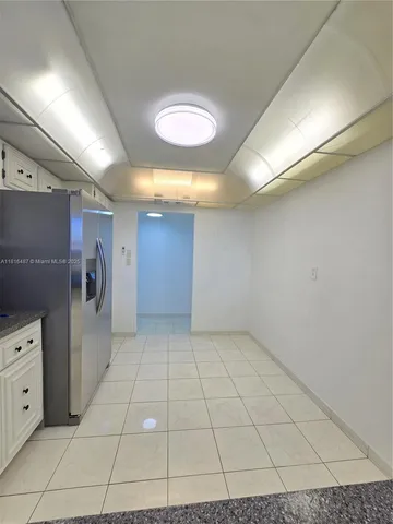 a kitchen with stainless steel appliances a refrigerator sink and cabinets