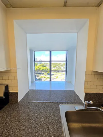a view of an empty room with a fireplace