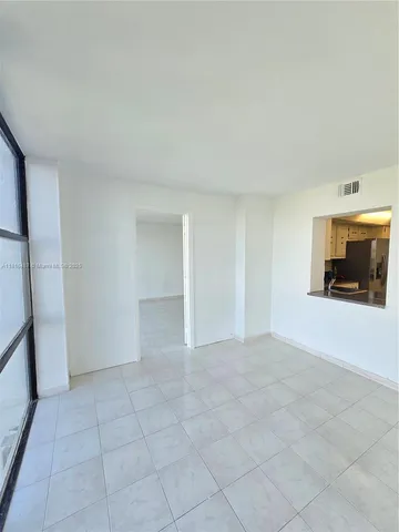 a view of an empty room with a sink and a mirror