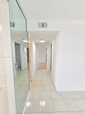 a view of an empty room with closet