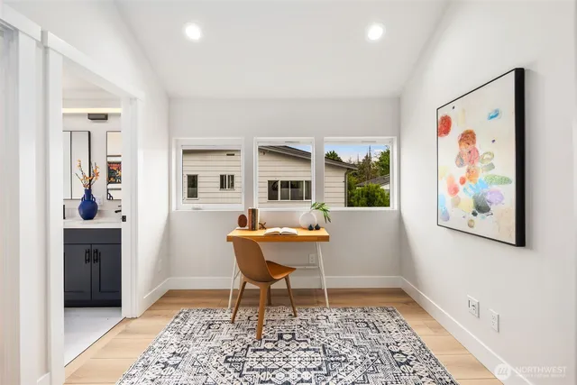 a workspace room with furniture and a rug
