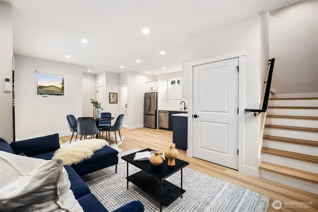 a living room with furniture and wooden floor