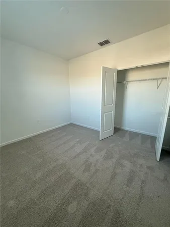 an empty room with closet area