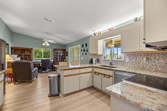 a kitchen with sink cabinets and wooden floor