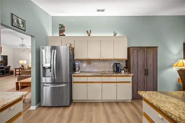 a kitchen with a refrigerator and a sink