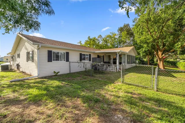 a view of a house with backyard and swimming pool