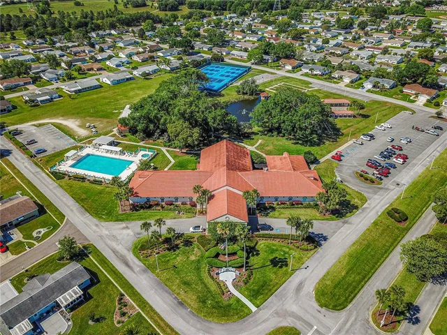 an aerial view of a house with a garden and lake view