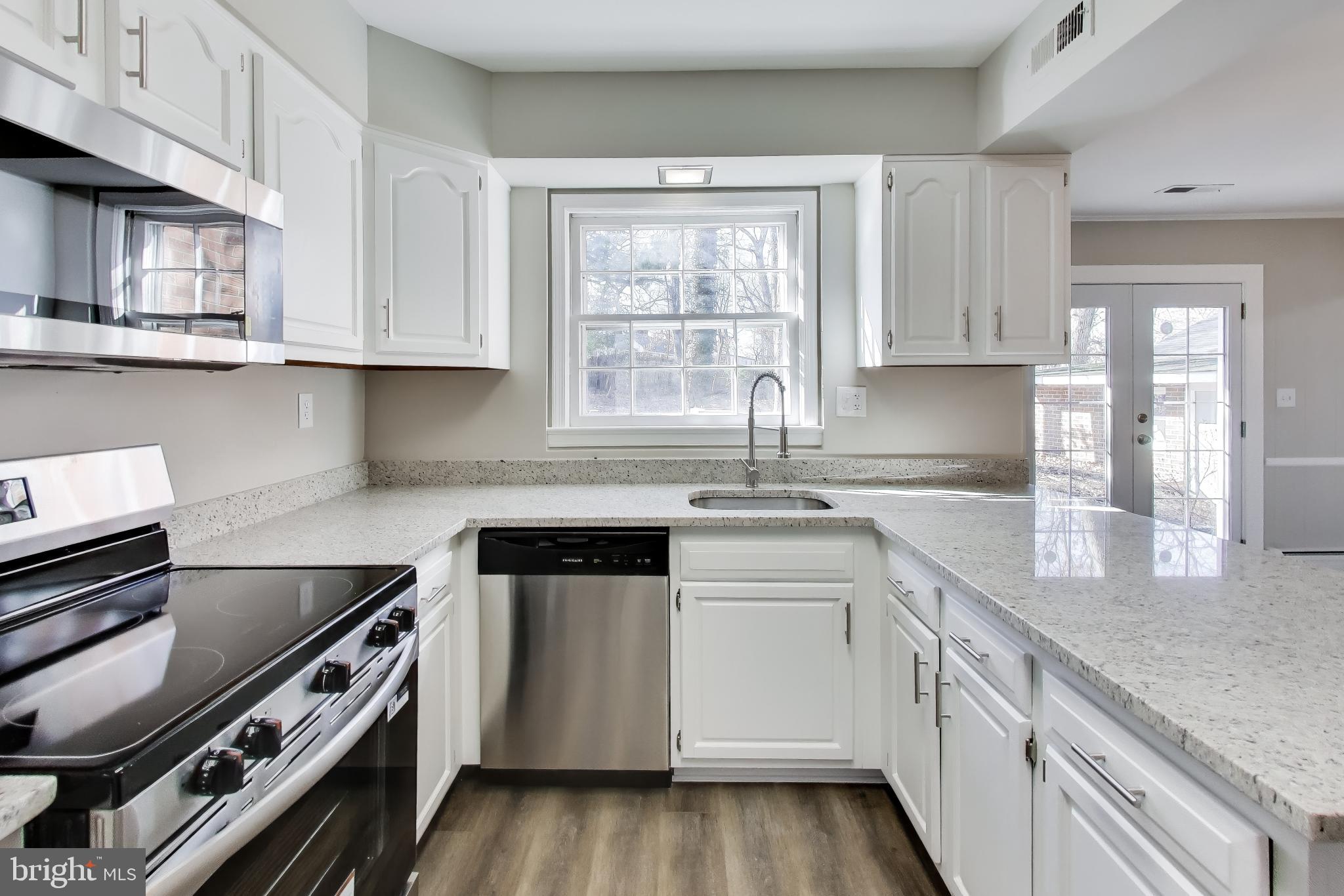 4007 Harrison Road Beltsville, MD 20705 - Photo 12 of 49 a kitchen with a sink stove top oven and cabinets