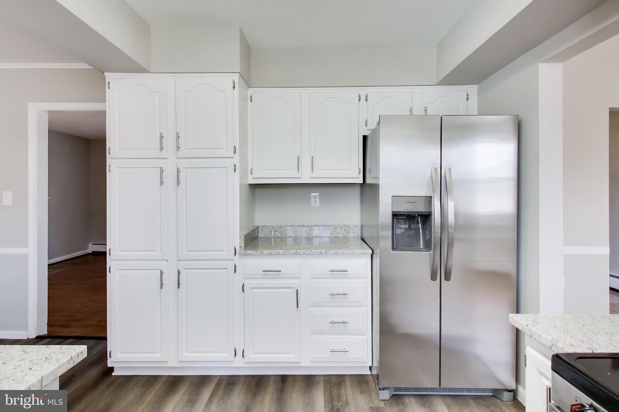4007 Harrison Road Beltsville, MD 20705 - Photo 13 of 49 a kitchen with white cabinets and refrigerator