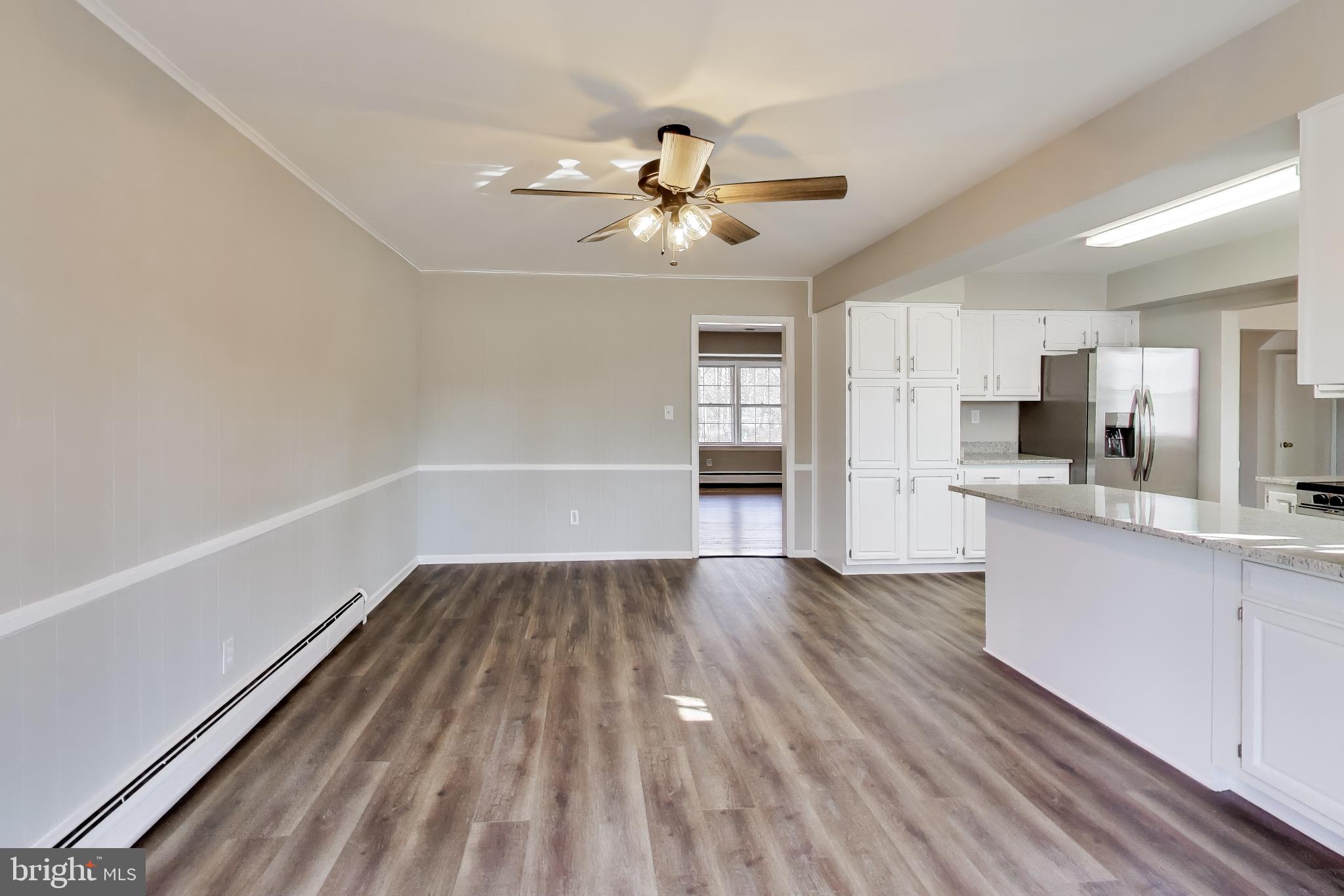 4007 Harrison Road Beltsville, MD 20705 - Photo 15 of 49 a view of a kitchen with wooden floor and a sink