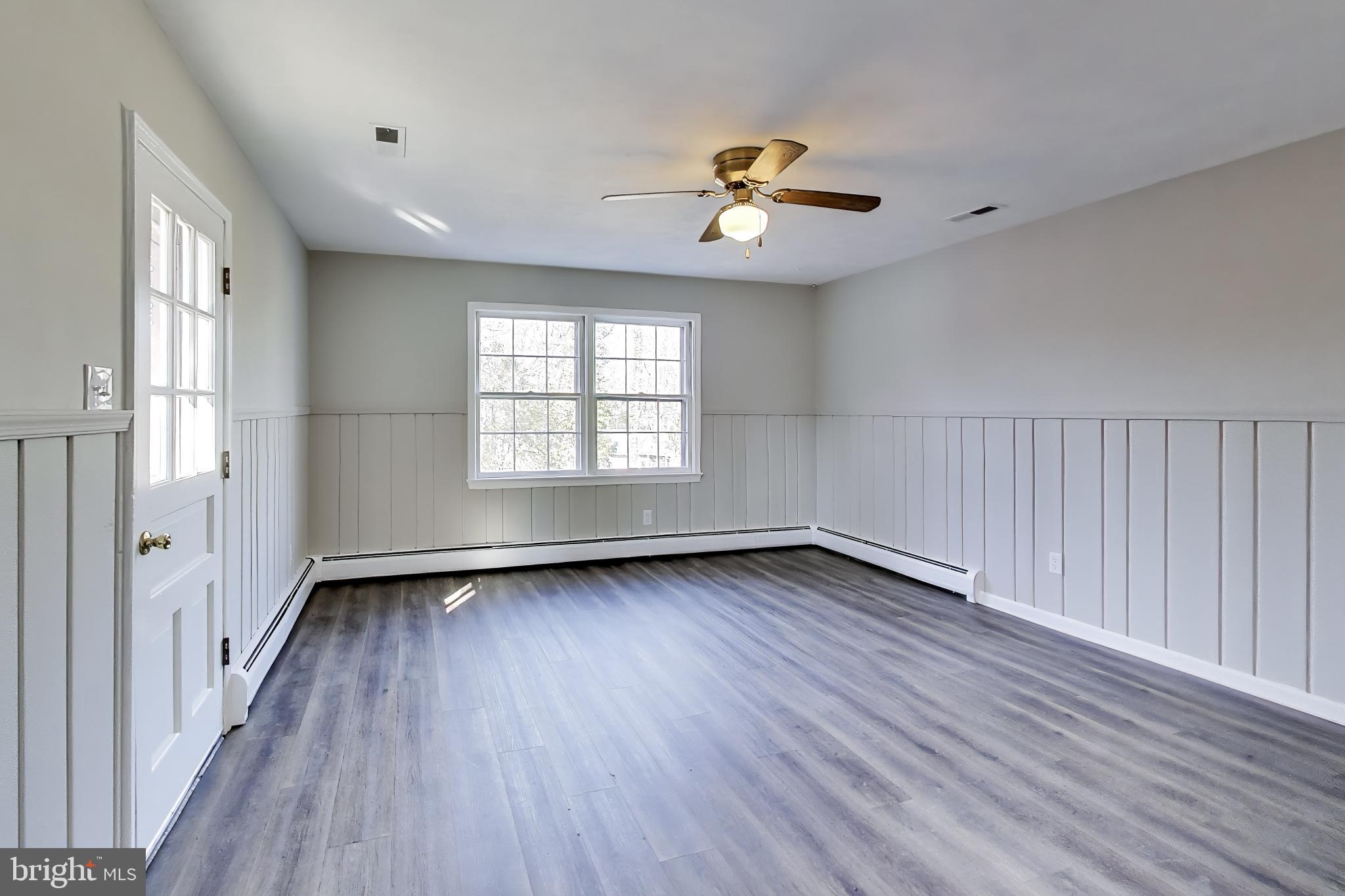 4007 Harrison Road Beltsville, MD 20705 - Photo 16 of 49 a view of an empty room with wooden floor and a window