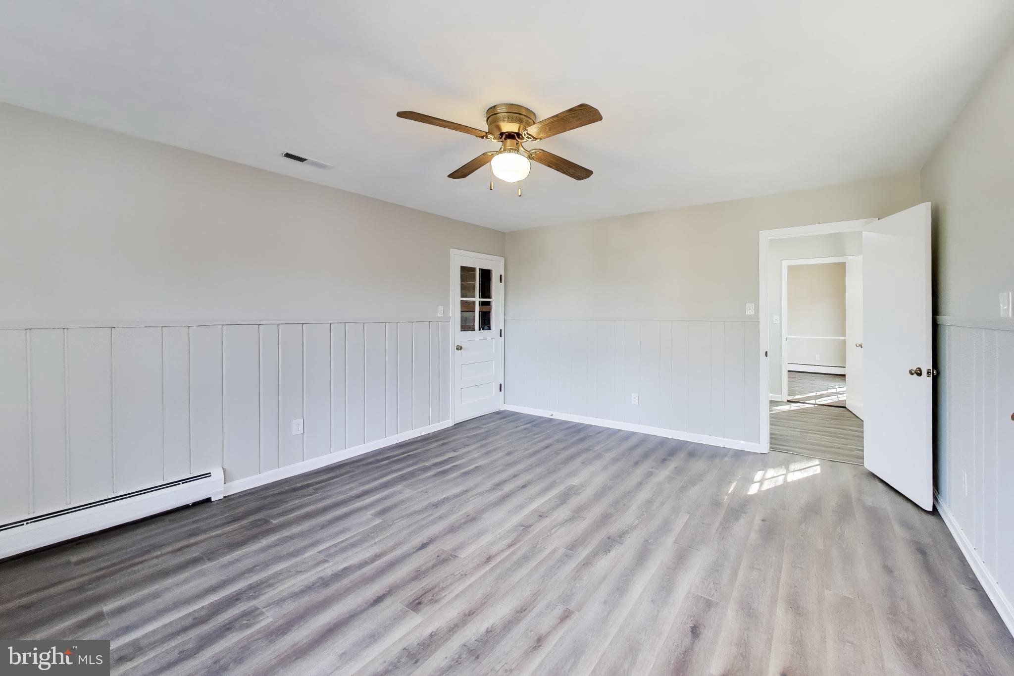 4007 Harrison Road Beltsville, MD 20705 - Photo 18 of 49 wooden floor in an empty room with a window