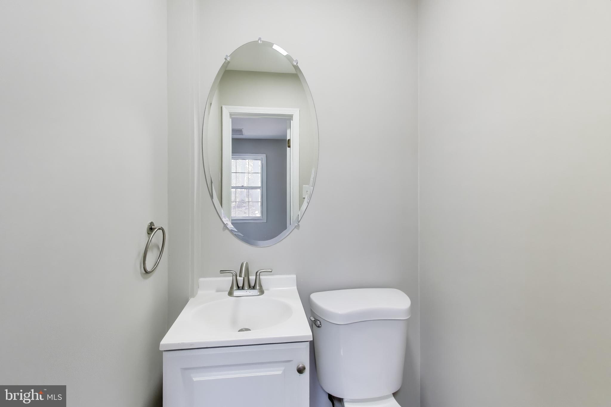 4007 Harrison Road Beltsville, MD 20705 - Photo 19 of 49 a bathroom with a toilet a sink and mirror