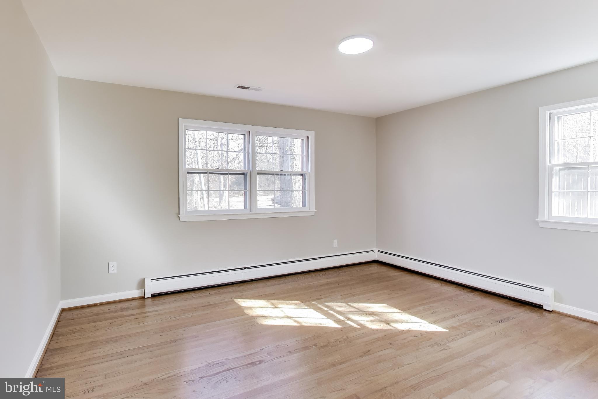 4007 Harrison Road Beltsville, MD 20705 - Photo 20 of 49 an empty room with wooden floor and windows