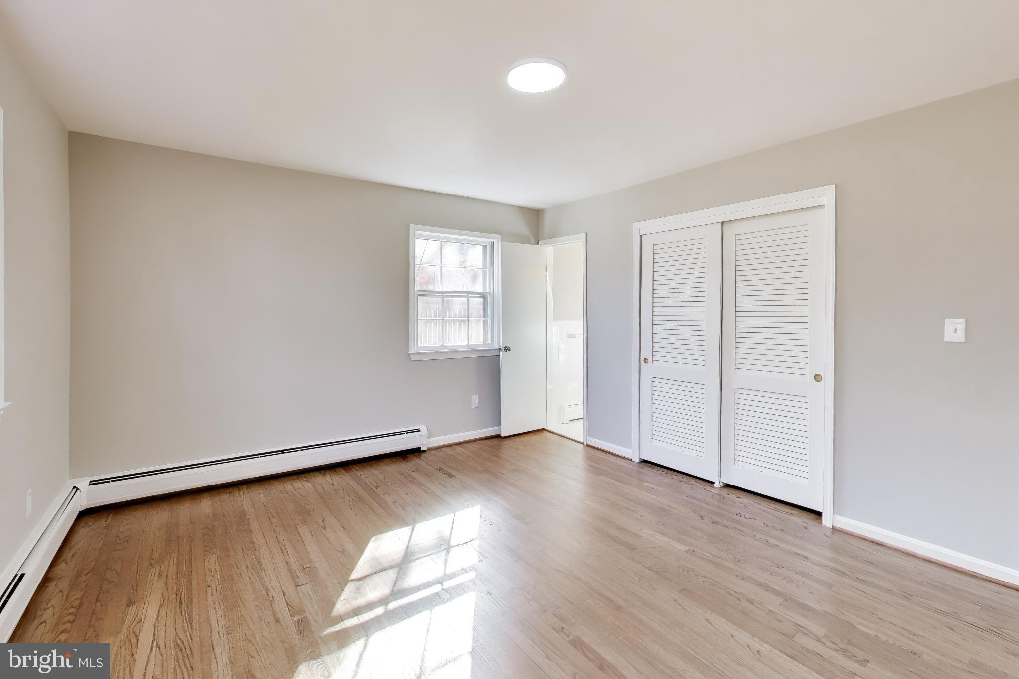 4007 Harrison Road Beltsville, MD 20705 - Photo 21 of 49 an empty room with wooden floor and windows