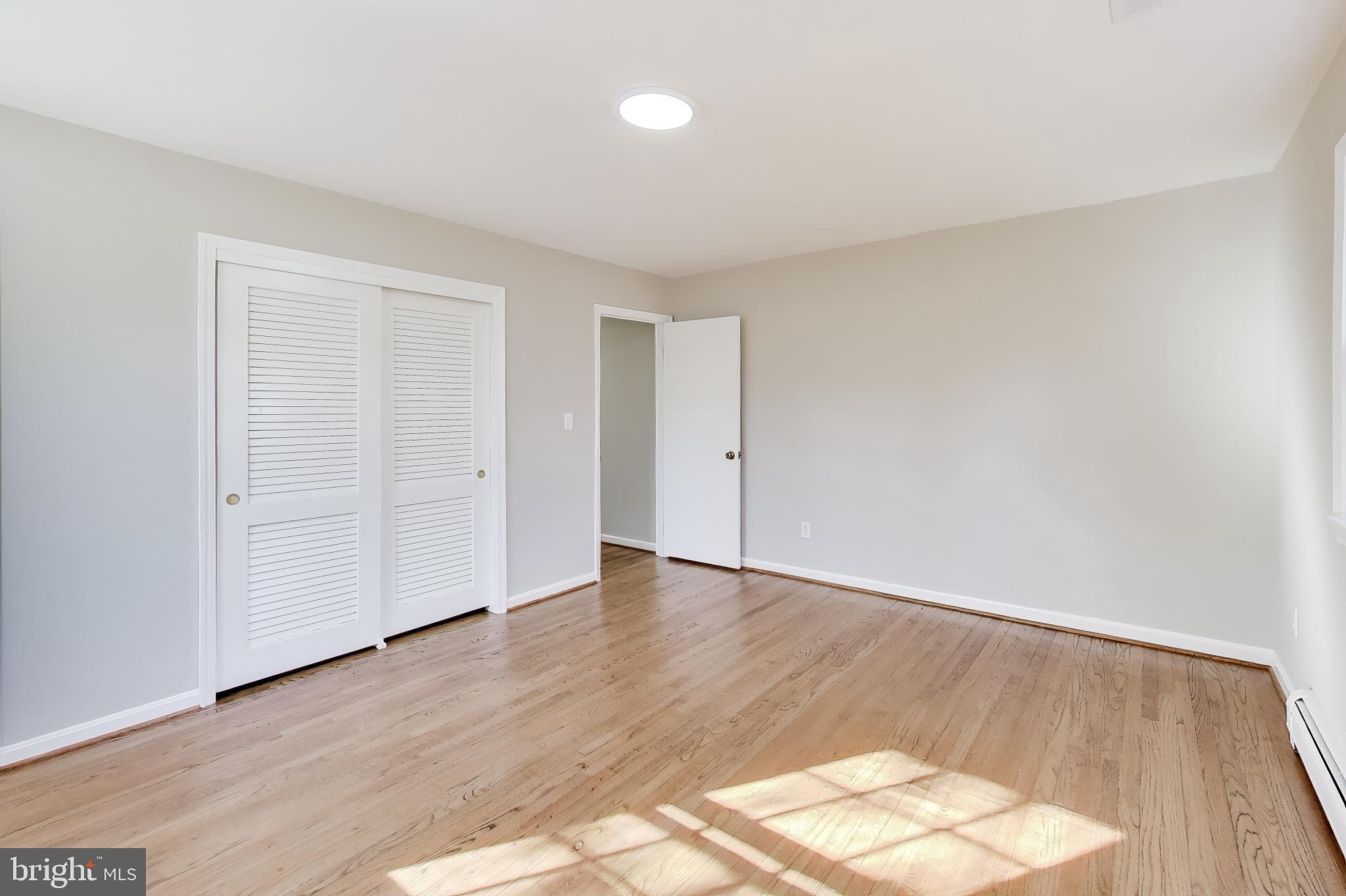 4007 Harrison Road Beltsville, MD 20705 - Photo 22 of 49 an empty room with wooden floor and windows