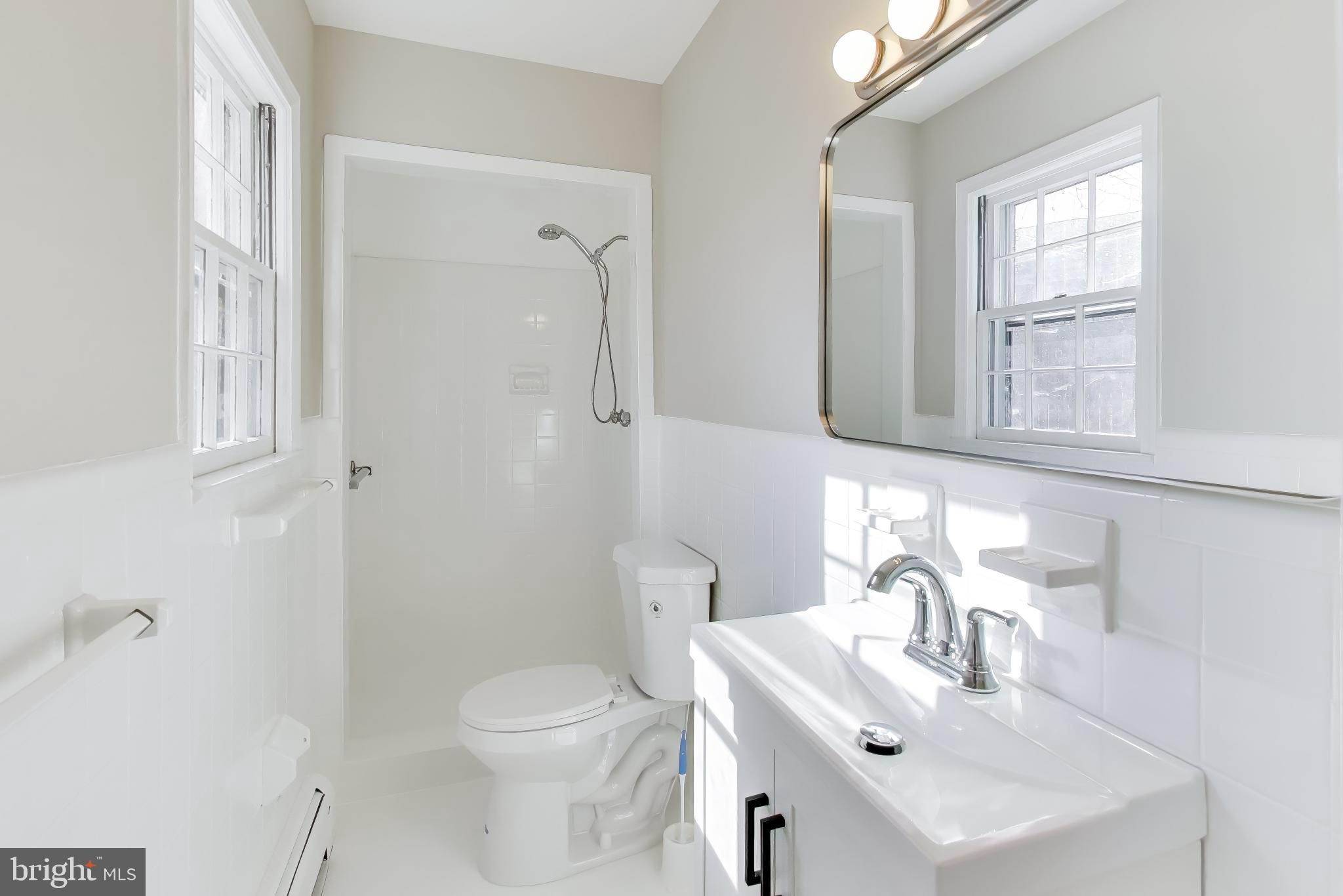 4007 Harrison Road Beltsville, MD 20705 - Photo 23 of 49 a bathroom with a sink toilet and mirror
