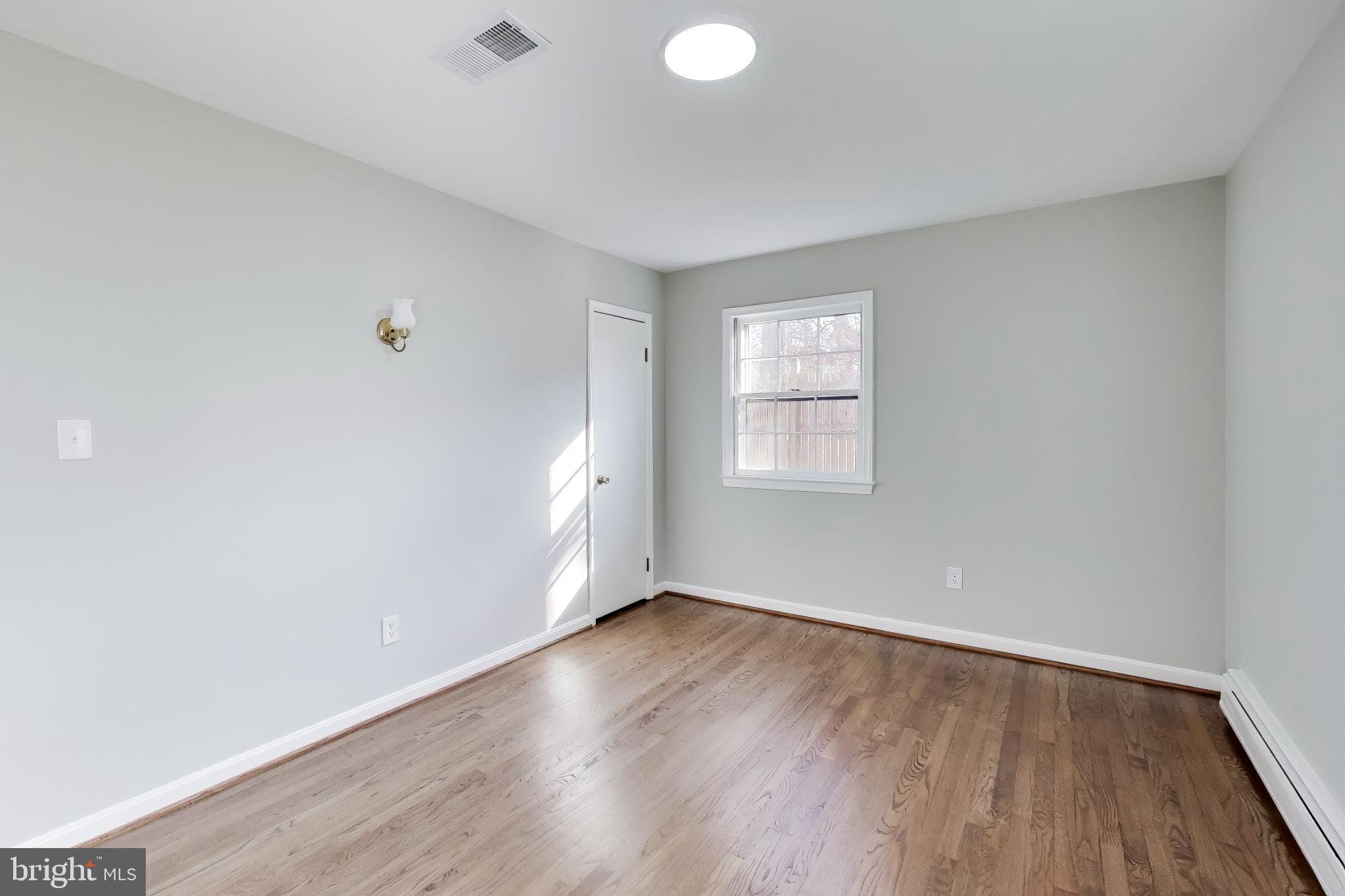 4007 Harrison Road Beltsville, MD 20705 - Photo 24 of 49 an empty room with wooden floor and windows