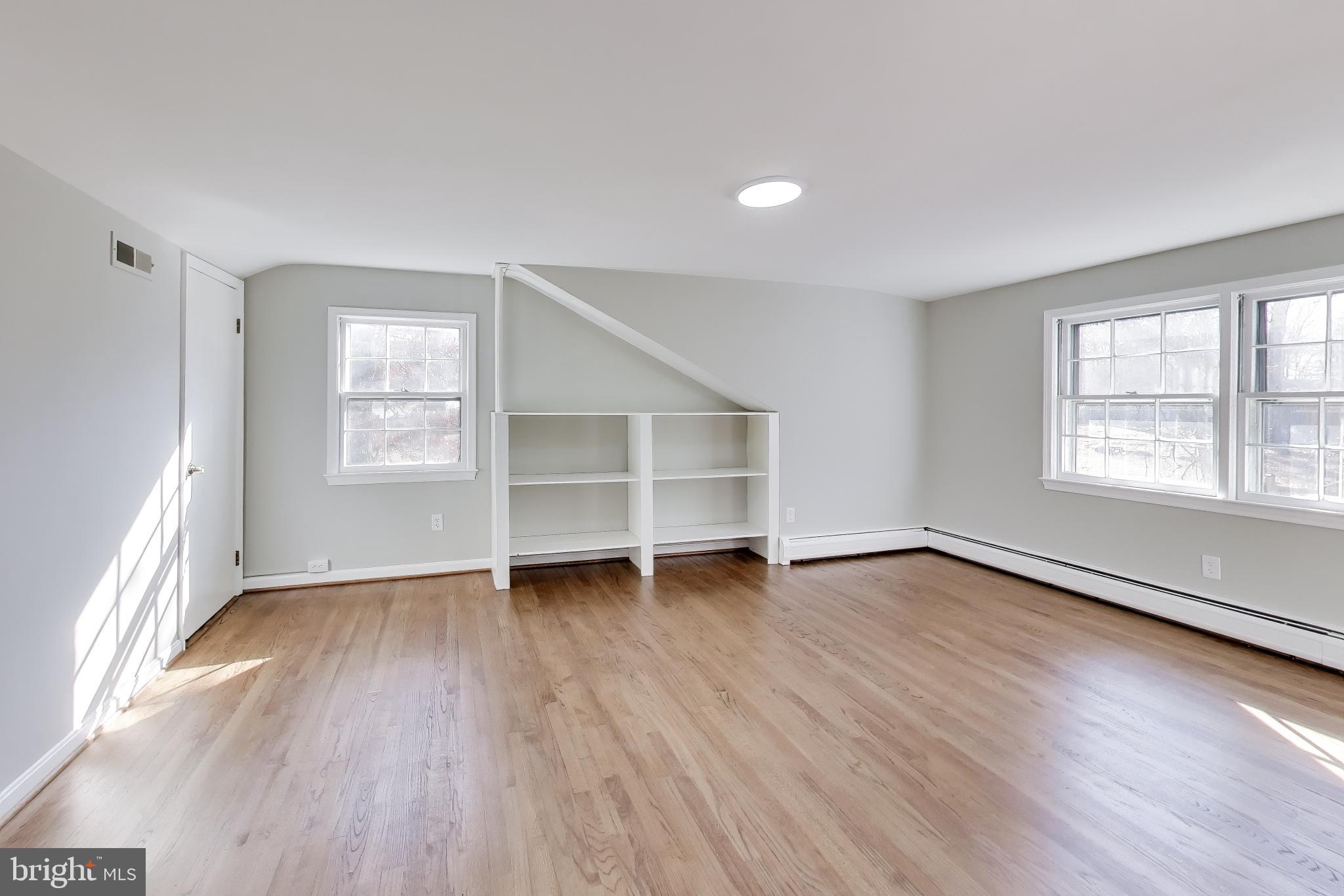 4007 Harrison Road Beltsville, MD 20705 - Photo 28 of 49 an empty room with wooden floor closet and windows