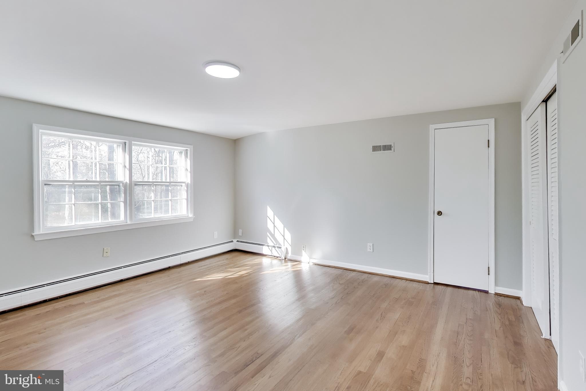 4007 Harrison Road Beltsville, MD 20705 - Photo 30 of 49 a view of an empty room with wooden floor and a window
