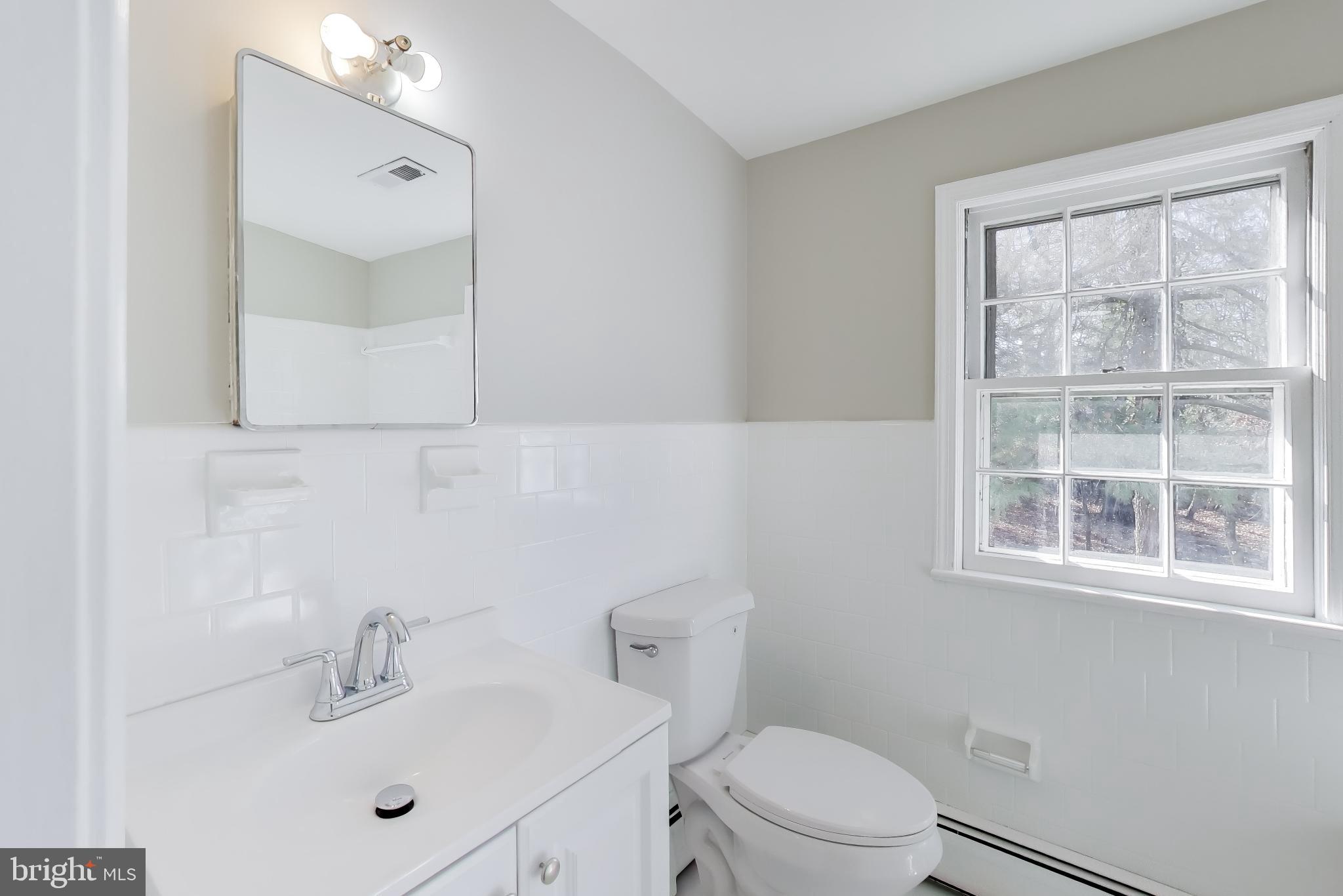4007 Harrison Road Beltsville, MD 20705 - Photo 35 of 49 a bathroom with a sink a toilet and shower