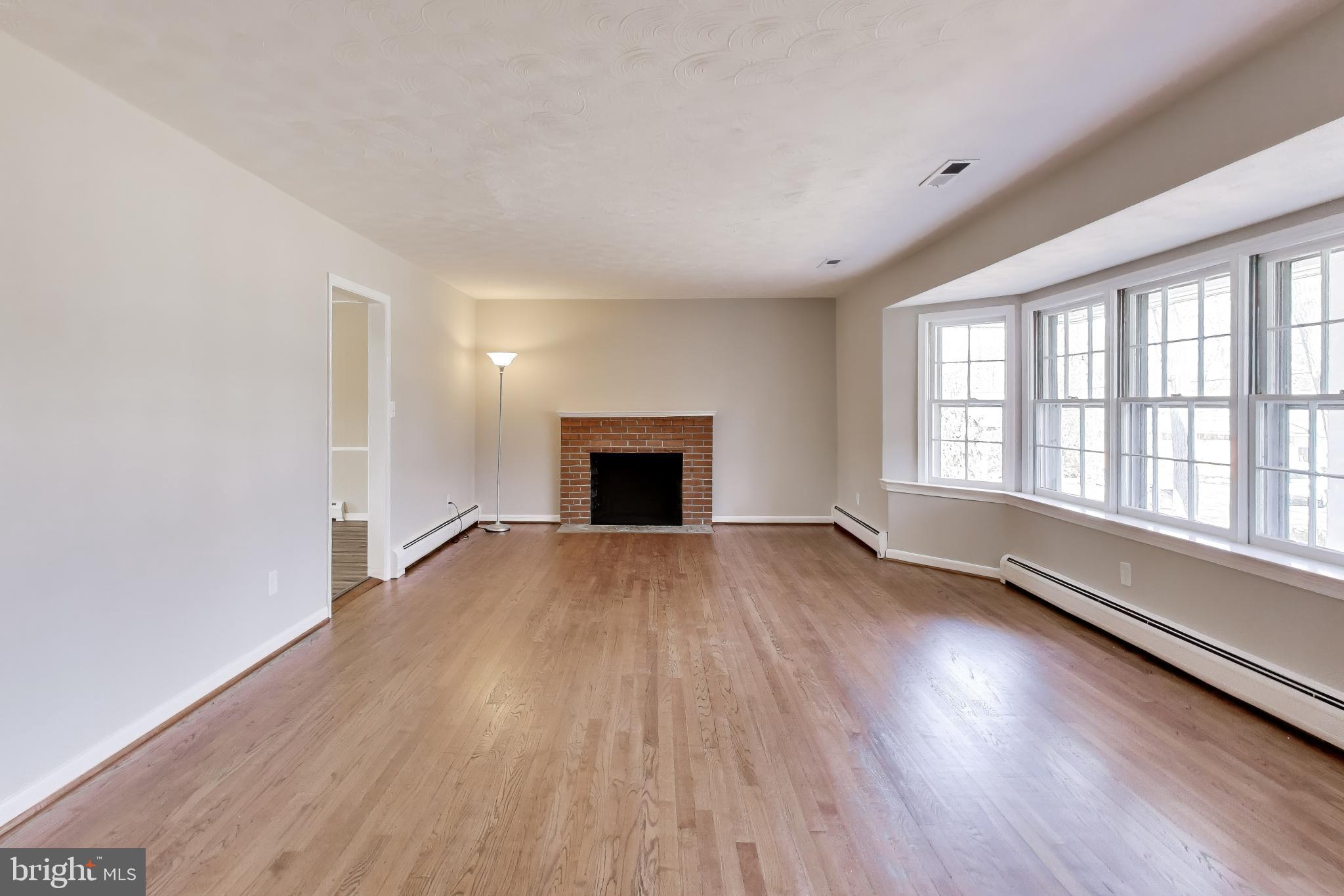 4007 Harrison Road Beltsville, MD 20705 - Photo 6 of 49 wooden floor in an empty room with a window