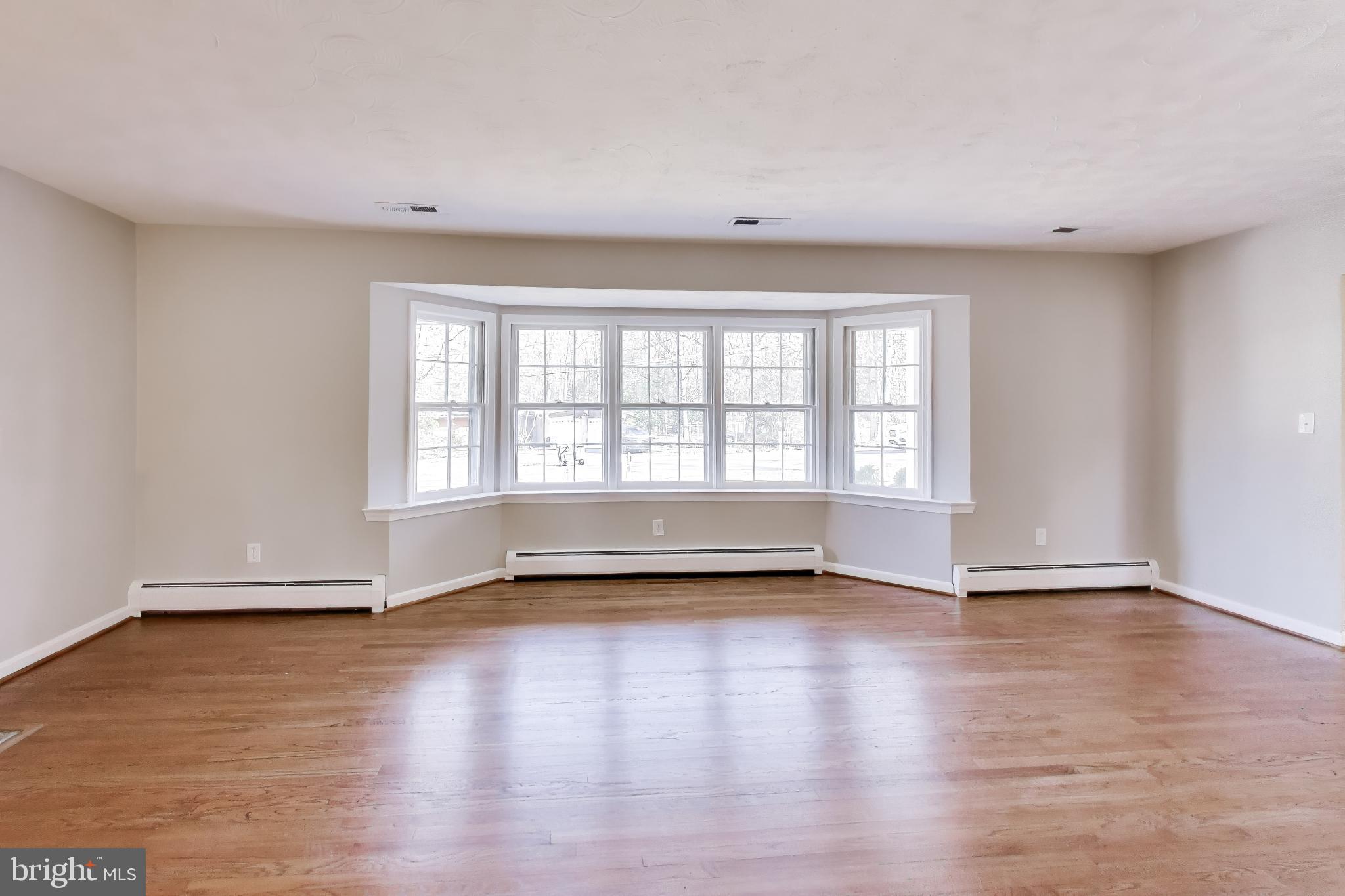 4007 Harrison Road Beltsville, MD 20705 - Photo 7 of 49 a view of an empty room with glass window and hardwood floor
